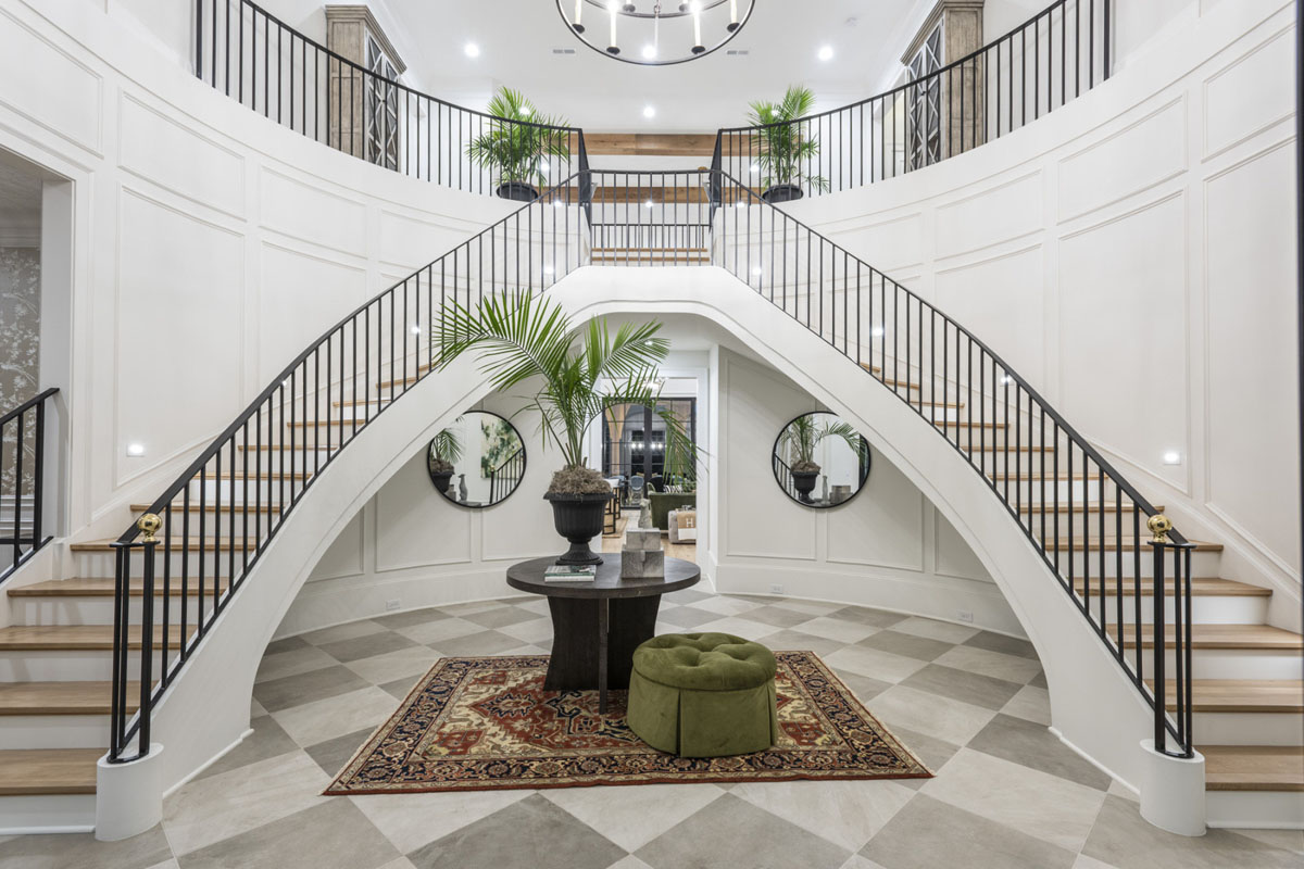 Dramatic Double Staircases with Custom Black Iron Railing